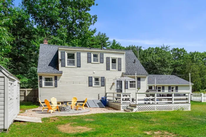 Exterior view of the back of the property showcasing its expansive yard—perfect for relaxation and outdoor fun!