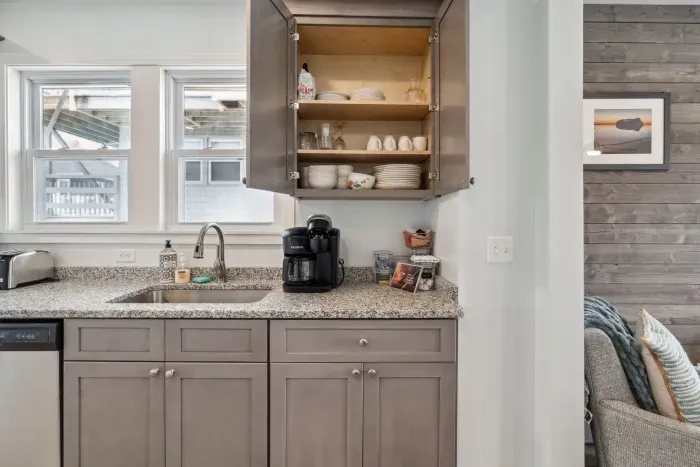 Fully equipped kitchen with updated appliances, washer/dryer unit, and 4-person dining table