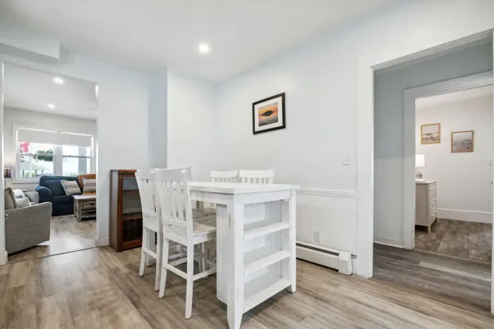 Fully equipped kitchen with updated appliances, washer/dryer unit, and 4-person dining table