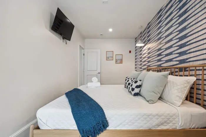 Bedroom #3 with king bed, smart TV, and cozy reading nook