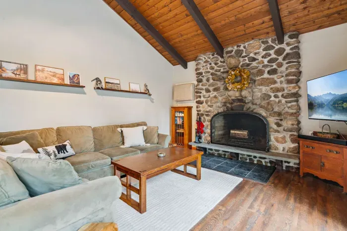 Living room with large couch and Smart TV! (please note fireplace is inoperable)