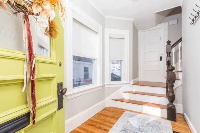 The front entry way with stairs leading to the top floor.