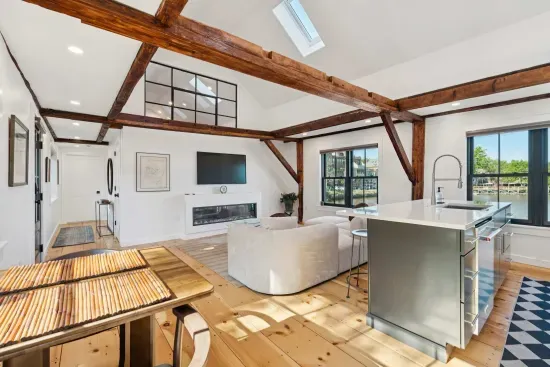Open concept kitchen and living are with vaulted ceilings and high end finishes. Featuring stunning river views.