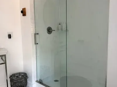 Full Bathroom with glass standing shower. Washer and dryer are located in this room.