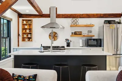 Open concept kitchen and living are with vaulted ceilings and high end finishes.