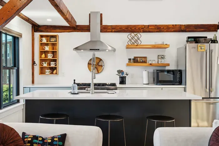 Open concept kitchen and living are with vaulted ceilings and high end finishes.