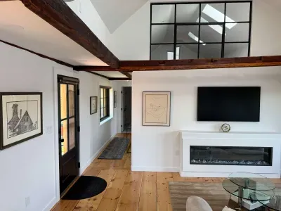 Living room has a electric fireplace and smart TV.