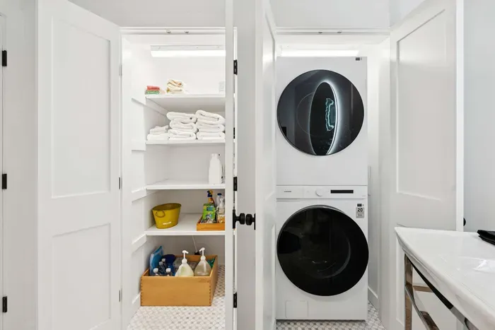 Full size washer and dryer located in the bathroom closet.