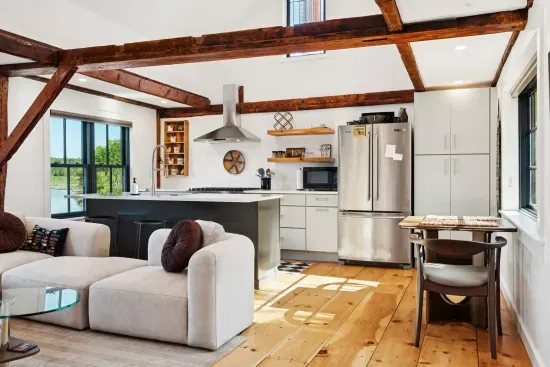 Open concept living room and kitchen. A newly renovated space with high end touches. Featuring stunning river views.