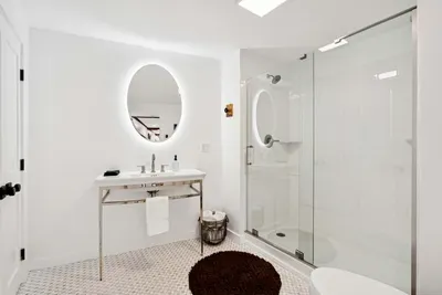 Full Bathroom with glass standing shower. Washer and dryer are located in this room. Clean towels, and shampoo/body wash are provided.
