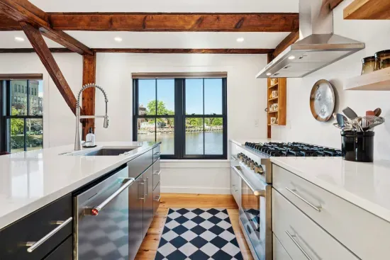 Open concept kitchen and living are with vaulted ceilings and high end finishes. Featuring stunning river views.