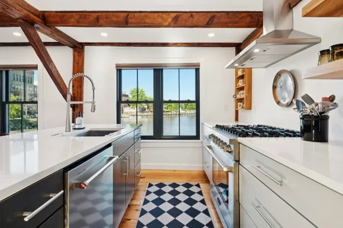 Open concept kitchen and living are with vaulted ceilings and high end finishes. Featuring stunning river views.