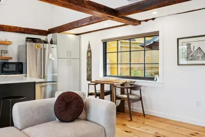 Living room features an spacious sectional, electric fireplace, and smart TV. There are also river views.