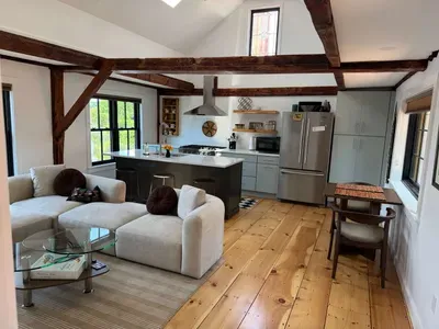 Open concept kitchen and living are with vaulted ceilings and high end finishes.