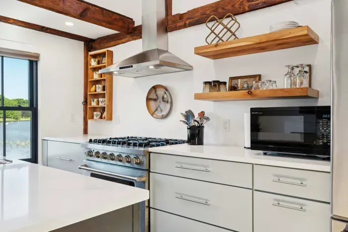 Open concept kitchen and living are with vaulted ceilings and high end finishes. Featuring stunning river views.