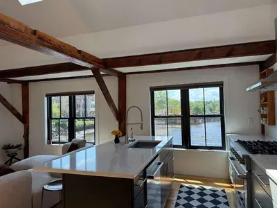 Newly renovated kitchen with high end appliances and views of the river. Seating for 3 at the kitchen island.