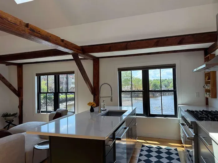 Newly renovated kitchen with high end appliances and views of the river. Seating for 3 at the kitchen island.