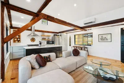 Living room features an spacious sectional, electric fireplace, and smart TV. There are also river views.