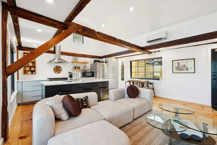 Living room features an spacious sectional, electric fireplace, and smart TV. There are also river views.