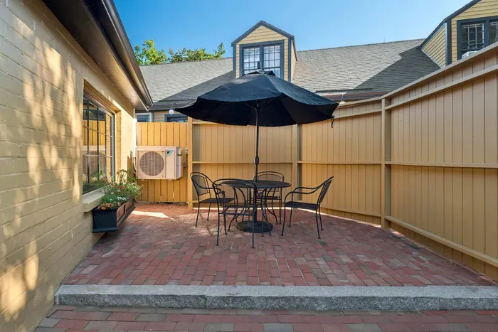 The outdoor courtyard also features an outdoor dining space suited for four people.
