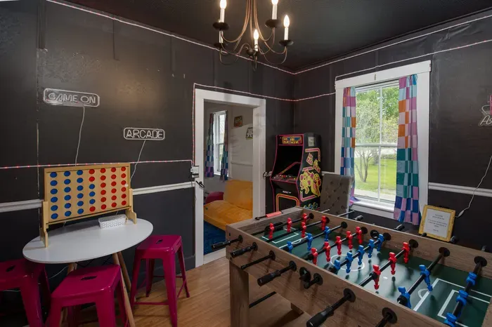 The Bridgewater Inn Main House- The Game Room, with ping pong, lots of games, another Roku TV and foosball in the adjacent room.