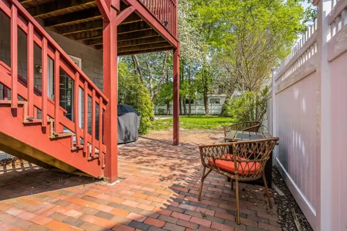 Back paved patio with lounge chairs and gas grill. Please note: We are in the process of upgrading our patio furniture. The patio will soon feature an outdoor table and chairs, perfect for outdoor meals and relaxation