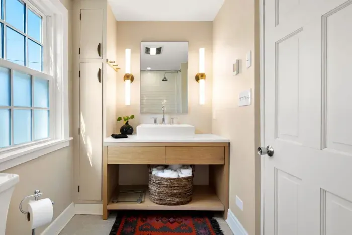 full bathroom with tiled shower tub, and stackable washer/dryer, located on the second level.