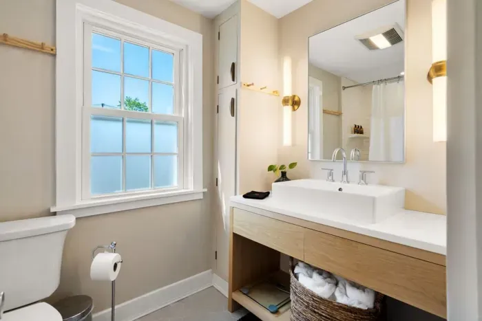 full bathroom with tiled shower tub, and stackable washer/dryer, located on the second level.