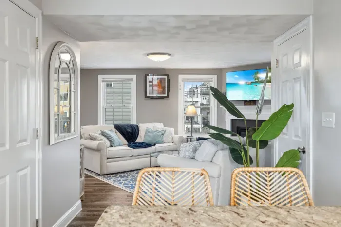 Fully equipped kitchen with updated appliances, coffee provided, and an island with seating for two.