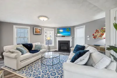 Cozy living room with a Smart TV, gas fireplace, and two comfy couches for a relaxing stay.