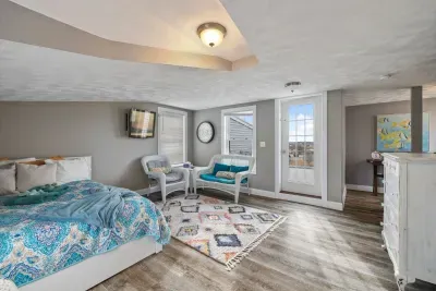 The queen bedroom located on the third floor! Access to the rooftop deck is located here. Please note there is not door to this bedroom but is the only room on this floor. Clean linens provided