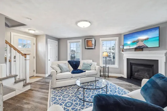 Cozy living room with a Smart TV, gas fireplace, and two comfy couches for a relaxing stay.