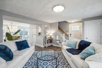 Cozy living room with a Smart TV, gas fireplace, and two comfy couches for a relaxing stay.