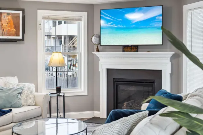 Cozy living room with a Smart TV, gas fireplace, and two comfy couches for a relaxing stay.