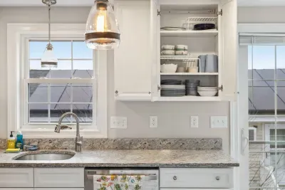 Fully equipped kitchen with updated appliances, coffee provided, and an island with seating for two.
