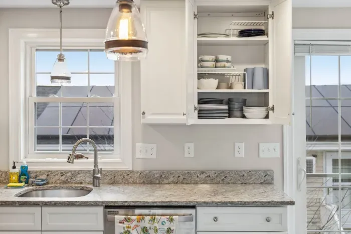 Fully equipped kitchen with updated appliances, coffee provided, and an island with seating for two.