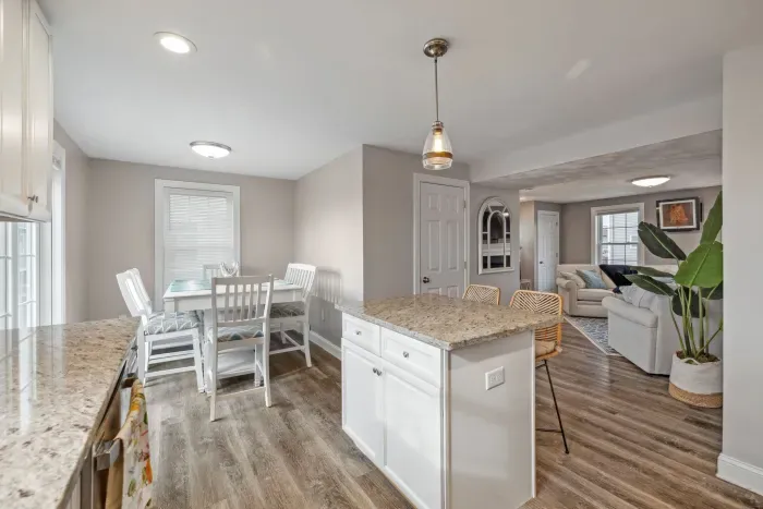 Fully equipped kitchen with updated appliances, coffee provided, and an island with seating for two.