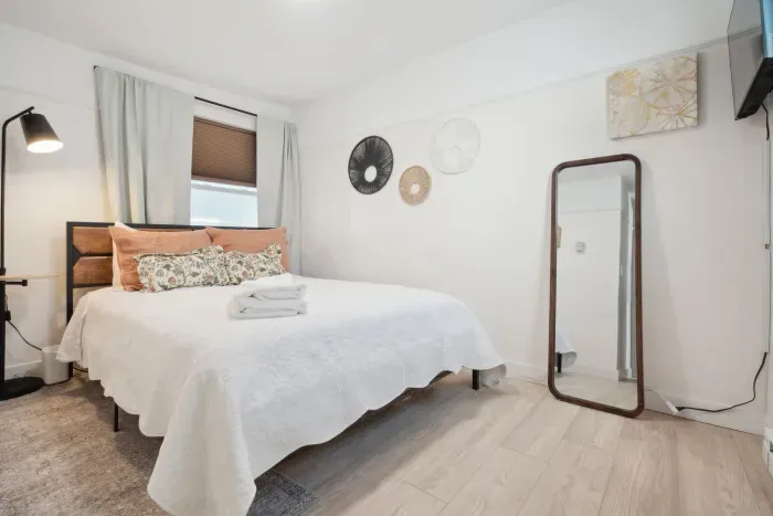 A queen bed paired with a full-body mirror—pure modern and chic! Smart TV and clean linens provided!