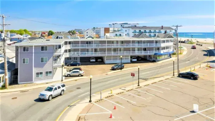 Aerial view of building, steps to beach and boardwalk.