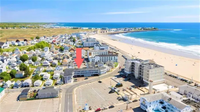 Aerial view of building, steps to beach and boardwalk.