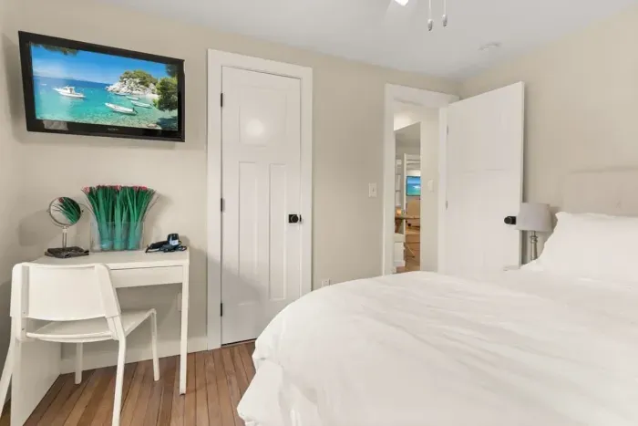 This 2nd cozy bedroom on the 1st floor features a comfortable queen-size bed and a TV, perfect for a relaxing evening after a day of exploring