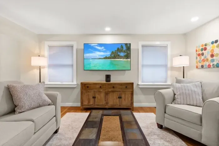 Relax and unwind in our cozy living room, complete with comfortable seating and a large TV for your entertainment.