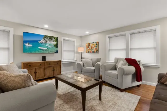 Relax and unwind in our cozy living room, complete with comfortable seating and a large TV for your entertainment.