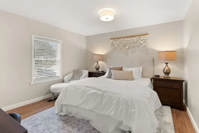 This is a cozy 1st-floor bedroom furnished with a comfortable queen-size bed.