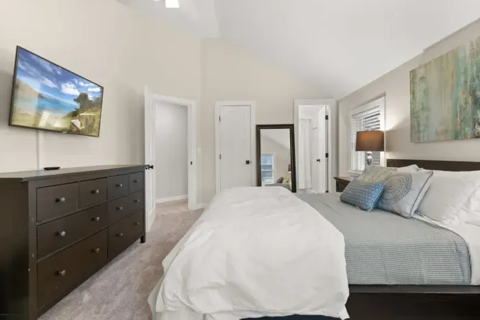 Cozy and spacious, the third bedroom is located on the second floor. It features a comfortable queen-size bed, a flat-screen TV, and a private ensuite bathroom.