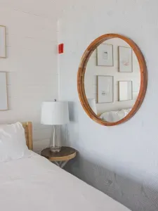The electrical panel is behind this mirror