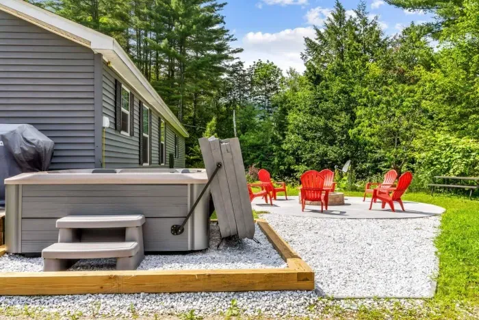 Hot tub with the patio & fire pit few feet behind. Please note, it is bring your own firewood.