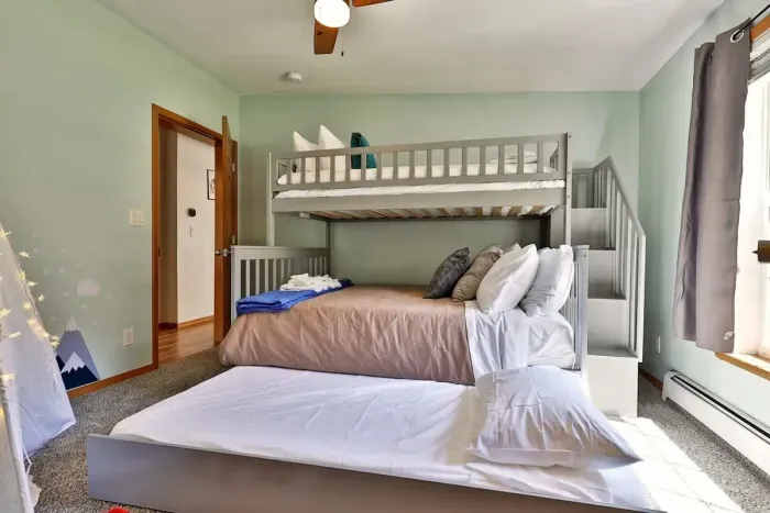This bedroom boasts a twin over full bunk with twin trundle, along with kids' tent and 'firepit'