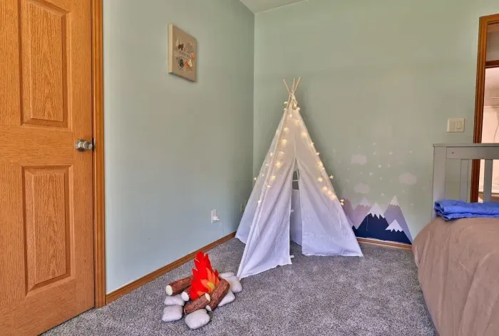 This bedroom boasts a twin over full bunk with twin trundle, along with kids' tent and 'firepit'