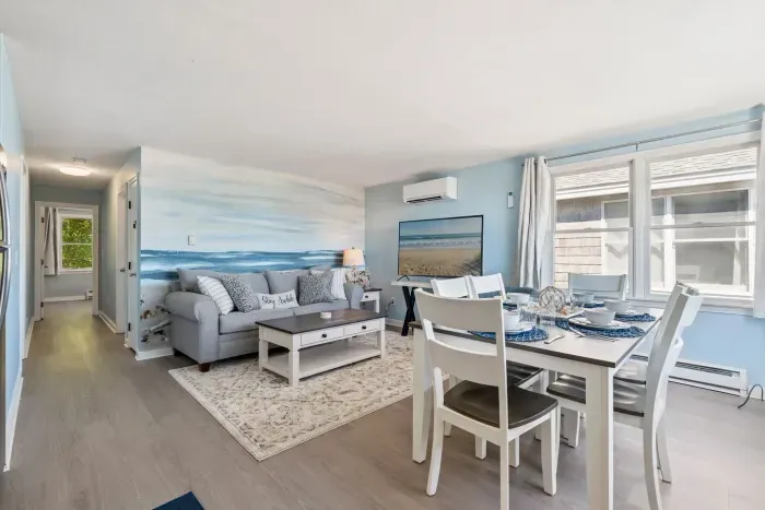 Fully equipped open kitchen, dining, and living room with a large Smart TV.